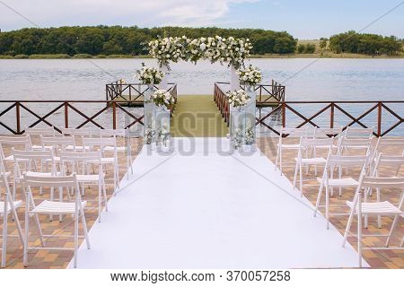 Wedding. Ceremony. Wedding Arch. Wedding Arch Made Of Branches, Flowers And Greenery Is On The Green