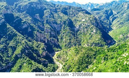 Aerial View Of Green Mountain Mountain Peak With Beautiful Blue Sky. Landscape Of Mountain In Natura