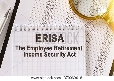 On The Table Are Financial Reports, A Pen, A Magnifying Glass And A Notebook With The Inscription - 