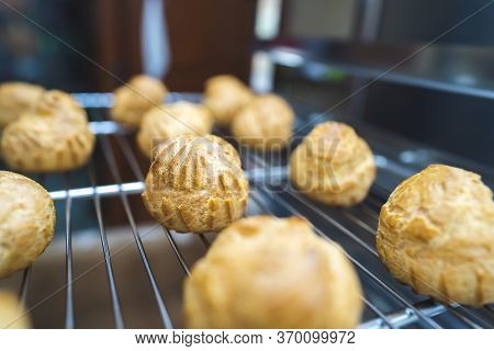 Close Up Choux Baked Home Made  Fresh Crispy Eclairs And Profiteroles. Making Desserts And Sweets On
