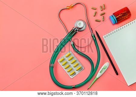 Concept, Of Medical Equipment, Flat Lay Top View. A Stethoscope On A Pink Background. Health Checkup
