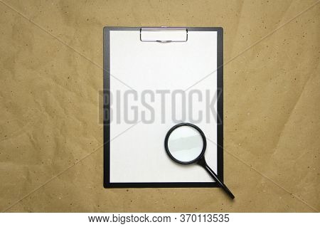 A Tablet With A White Sheet Of A4 Format With Magnifier On A Beige Craft Paper. Concept Of Analysis,