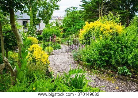 Colourful Glebe Garden Summer Flower Garden With A Path Under Archway