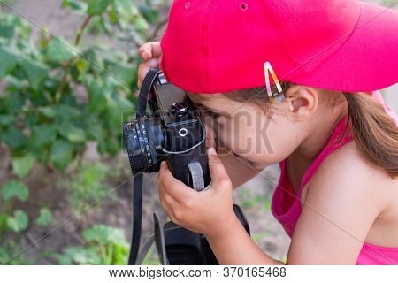Little Girl Shooting Blog On Retro Photo Camera сlose Up.
