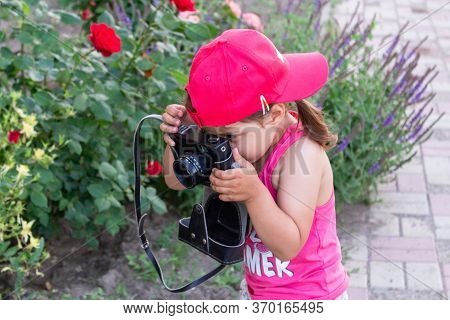 Little Girl Shooting Blog On Retro Photo Camera сlose Up.