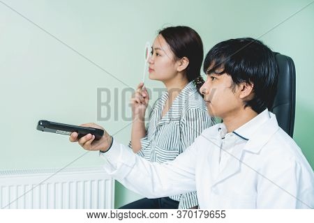 Consultation With An Ophthalmologist. Young Asian Woman And Doctor