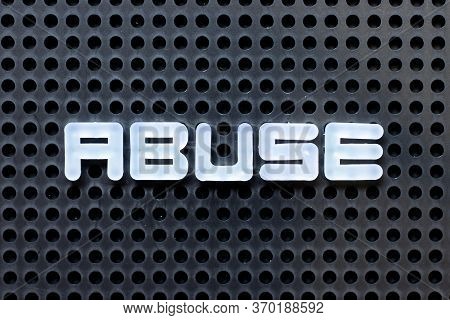 White Color Alphabet With Word Abuse On Black Pegboard Background