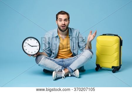 Puzzled Traveler Tourist Man In Summer Yellow Casual Clothes Isolated On Blue Wall Background. Male 