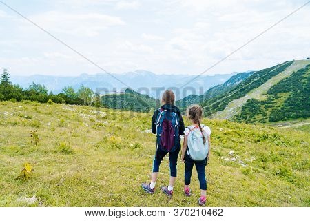 Children Hiking On Beautiful Summer Day In Alps Mountains Austria, Resting On Rock And Admire Amazin