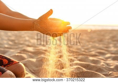 Little Boy Playing With Sand On The Beach At Sunset In California, Closeup Of Hands At Natural Sunli