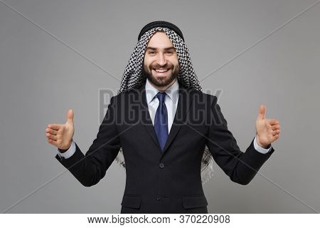 Arabian Muslim Businessman In Keffiyeh Kafiya Ring Igal Agal Classic Black Suit Isolated On Gray Bac