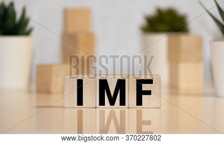 Imf Spelled With Wood Tiles Isolated On A White Background.