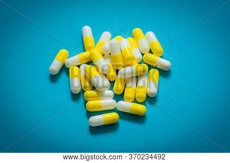 Lot Of Pills Capsules On Blue Background.  Antibiotics Drug Resistance. Antimicrobial Capsule Pills.