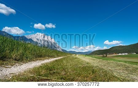 Path Trough Agriculural Meadows In Austrian Alps On Sunny Day With Blue Sky, Mieminger Plateau, Tyro