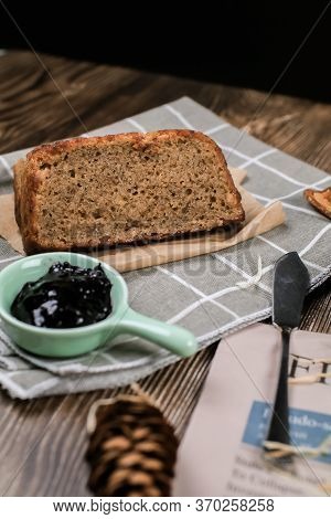 Top View Fresh Homemade Banana Bread And Sliced Bread On Cutting Board With Jam Strawberry And Blueb