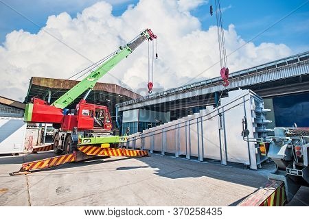 Mobile Crane Operating By Lifting And Moving An Heavy Electric Generator