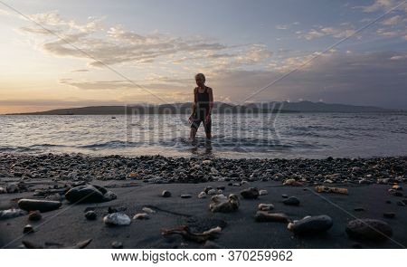Banyuwangi, Indonesia - May 14, 2020 : A Woman Playing With The Dogs At Watudodol Beach Banyuwangi E
