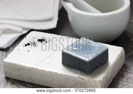 Handmade Soap With Activated Carbon On Marble, Carbon Powder And A Cotton Towel On A Gray Background