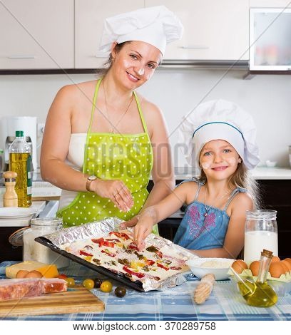 Smiling Woman With Her Daughter Preparing Piza
