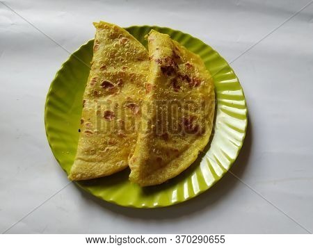 Group Of Yellow Color Traditional Dal Obbattu Or Holige In A Plate Isolated On White Background