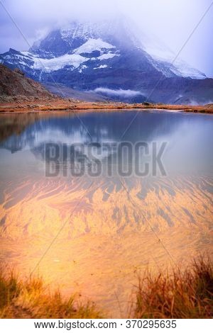 Colorful Pink Sunrise And Reflection Of Matterhorn Mountain At Riffelsee Lake, Zermatt Switzerland