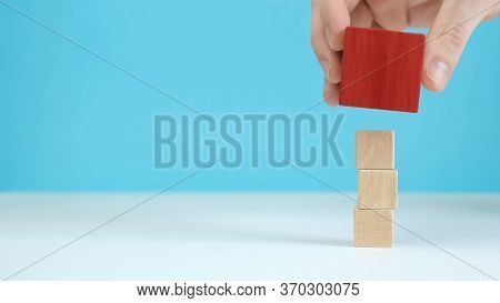 Hand Arranging Wood Block Stacking As Step Stair On Wooden Table. Business Concept For Growth Succes