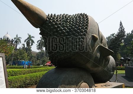 MUMBAI, INDIA - FEBRUARY 14, 2020: Statue of Buddhas head in the garden of the Prince of Wales Museum, now known as The Chhatrapati Shivaji Maharaj Museum in Mumbai, India