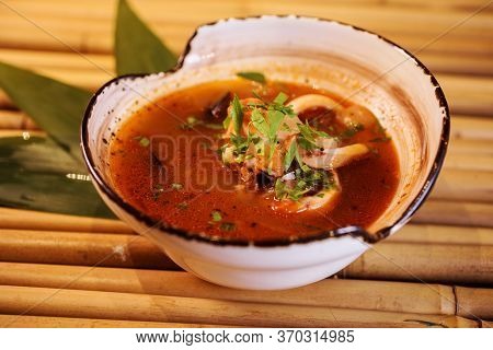 Bouillabaisse Soup Or Tom Yam On The Bamboo Background. Closeup View.
