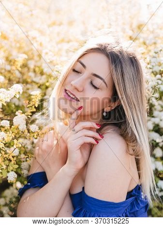 Sensual Calm Portrait Of Beautiful Hipster Woman In Blooming Bush With White Flowers Of Spirea. Copy