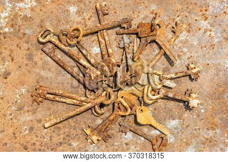 Several Old Rusty Keys On Ring Shot On Steel Textured Background