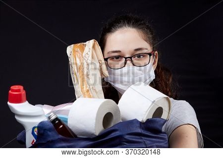 Young Woman In Protective Mask With A Bag Full Of Groceries From The Supermarket