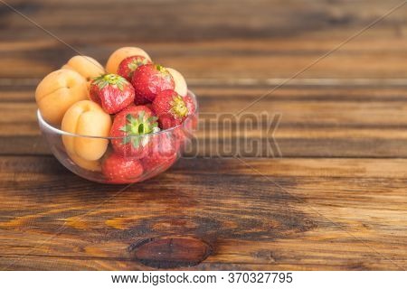 Fresh Sweet Summer Fruits And Berries. Strawberries And Apricots In Bowll On Wooden Background