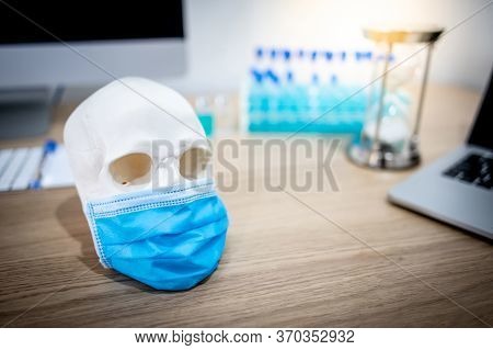 Human Skull Or Cranium Head Wearing Blue Surgical Mask With Test Tube Set And Computerl In Medical L