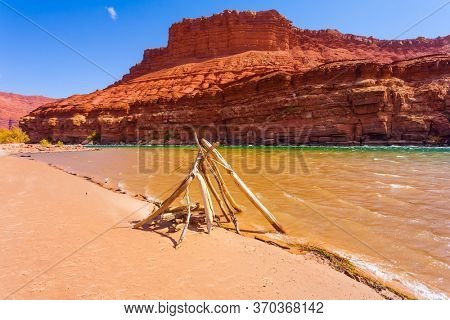 Dry branch construction by the river. The steep banks of red sandstone. Lee's Ferry is a historic boat ferry across the Colorado River. USA. The concept of active and photo tourism