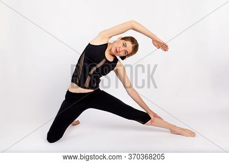 Beautiful Girl In Sports Uniform Doing Sports, On A White Background, Space For Tex