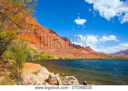 USA. Lee's Ferry is a historic boat ferry across the Colorado River. Wide river with rapids and steep banks of red sandstone. Amazing wildlife. The concept of active, extreme and photo tourism