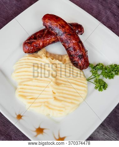 Potatoe With Sousages On The White Plate