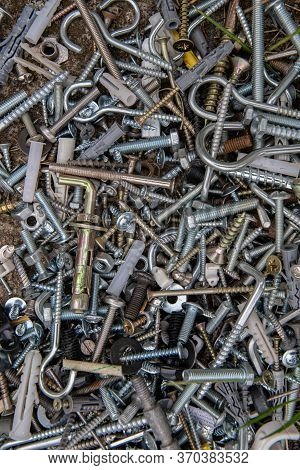 Old And New Assorted Metalware Bolts And Nuts Flat Lay. Work Tools Closeup. Abstract Industrial Back