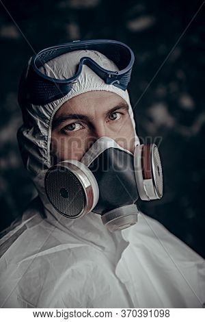 COVID-19 or 2019-nCoV. Portrait of a scientist microbiologist in a respiratory mask. Pandemic.