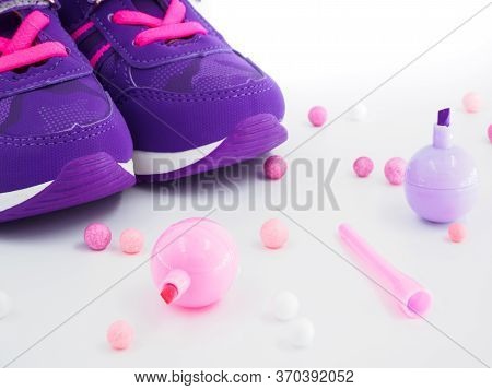Close Up View Of Violet Pink Childrens Sneakers With Pink And White Balls And Felt-tip Pens At Peach
