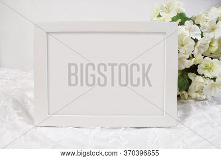 A Pretty 5x7 White Frame Rests Luxuriously Against A White Lacy Background Graced With White Hydrang