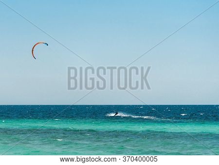 Extreme Water Sport - Kitesurfing At Sea On Hot Summer Sunny Day Copy Space. The Concept Of An Activ