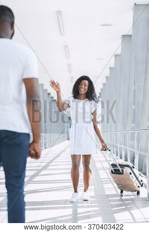 Post-quarantine Life Concept. Happy Black Couple Meeting In Airport, Greeting Each Other After Long 