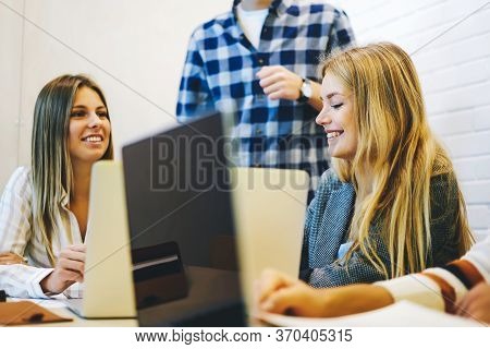 Young It Programmers Collaborating On Creating Application Using Digital Computers