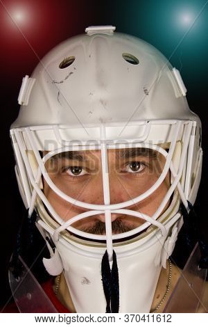 Detail Of A Male Face In A White Goalie Hockey Mask And  Colorful Lights.this Is A Detail Hockey Goa