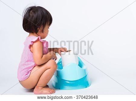 Asian Little Cute Baby Child Girl Education Training To Sitting On Blue Chamber Pot Or Potty With To