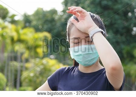 The Woman In Medical Protective Mask, She Tired From A Workout Rest. Female Athlete Suffering A Head