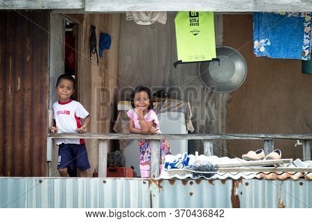 Mantanani Island, Sabah, Malaysia-circa September, 2017: Cute Kids Are Smell On Photographer While T