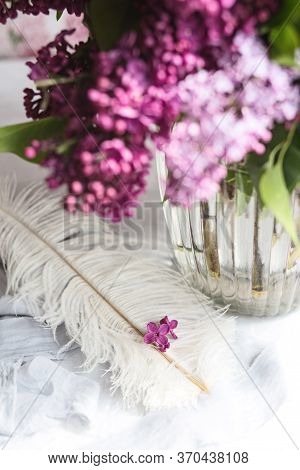 Five-pointed Lilac Blue Violet Flowers On A White Ostrich Feather. A Lilac Luck - Flower With Five P