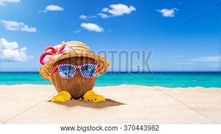 Coconut With Sunglasses And Strawhat At Tropical Beach - Holiday Vacation Concept